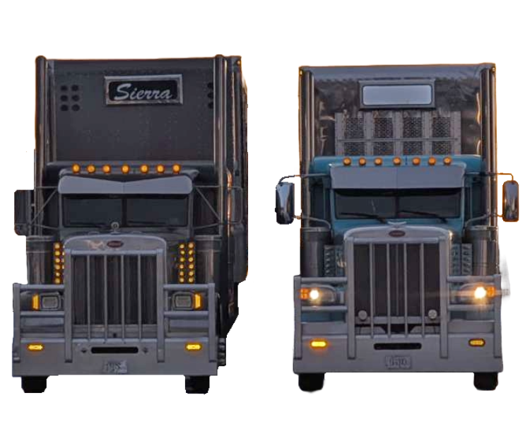 Two Peterbilt semi-trucks with their lights on connected to shiny silver livestock trailers. One livestock trailer has the name 